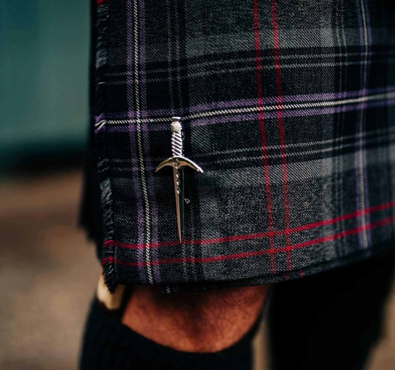 Close up of a man wearing a traditional Scottish kilt.